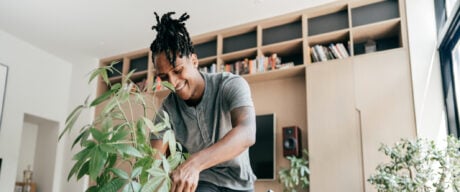 A happy millennial Black man smiling after investing in an EQ Bank TFSA.