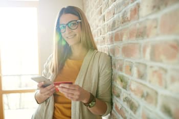Woman with credit card and smartphone