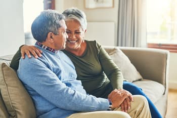 Older couple talking on sofa