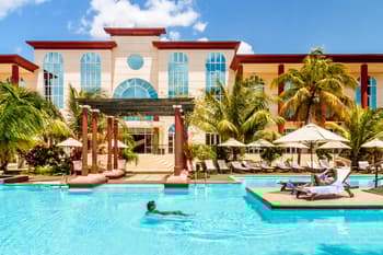 hyatt suite upgrade award being enjoyed by a woman in a resort pool