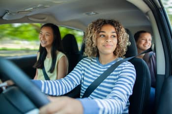 Group of female friends driving a car