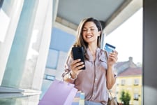 Woman holding a blue credit card