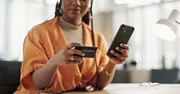 Woman with black coloured credit card