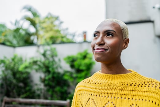 A contemplative young woman thinking about her savings in Scotiabank TFSA for her next vacation.