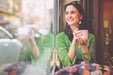 A young woman smiling after checking her EQ Bank TFSA savings account balance.