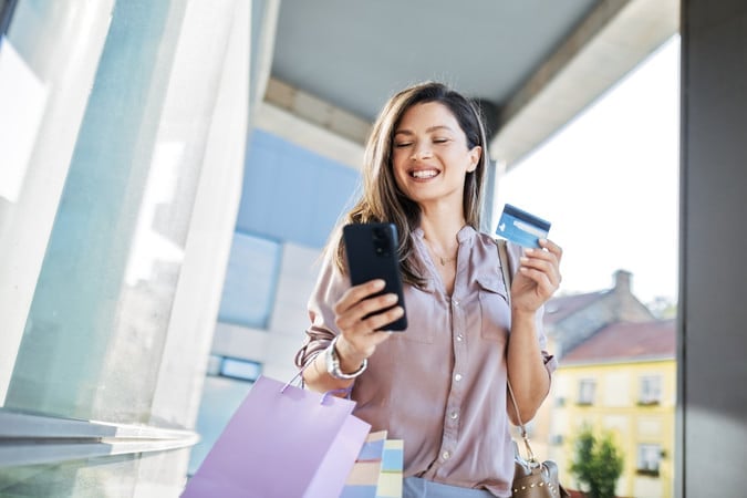 Woman holding a blue credit card