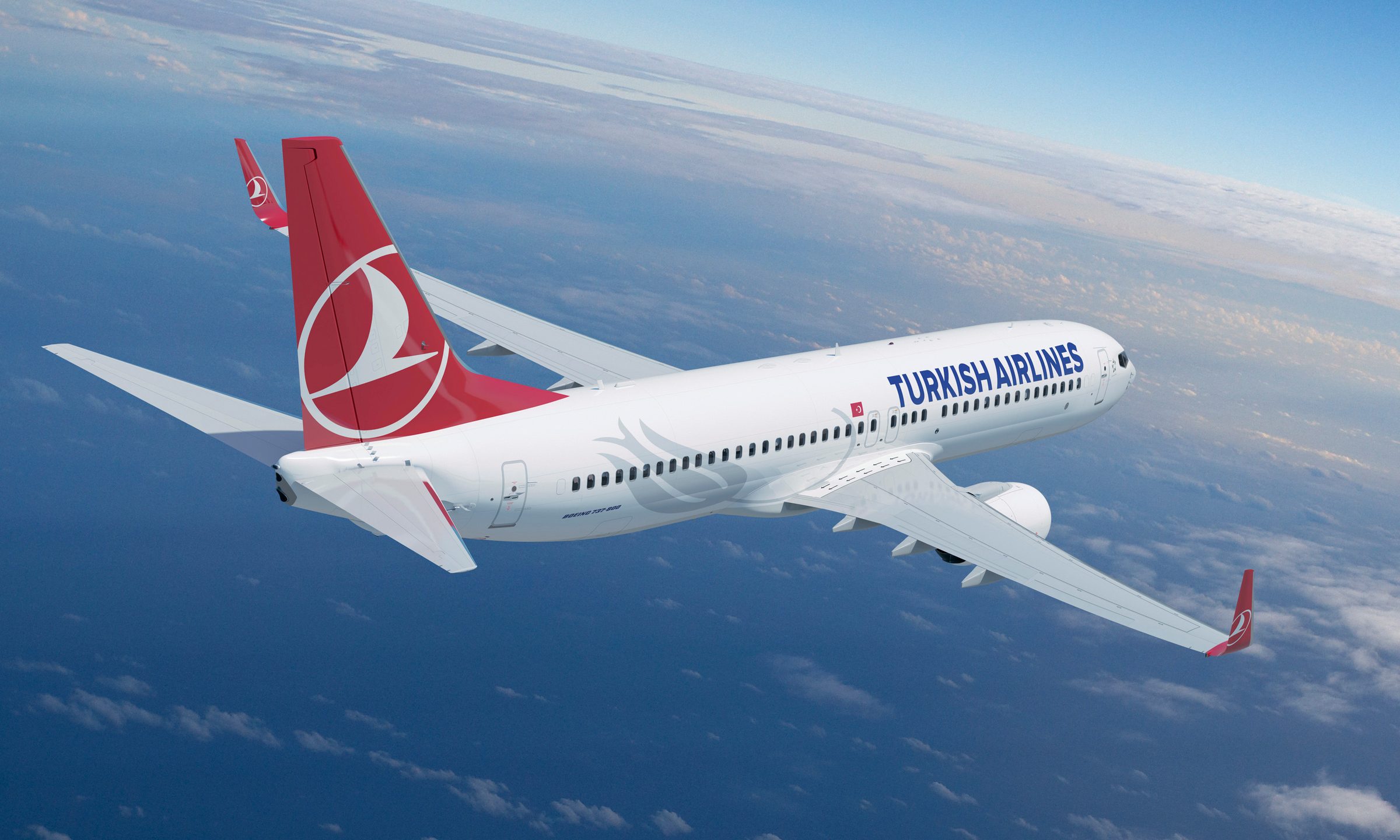 Turkish Airlines aircraft parked at the airport during sunset with crew and ground service in view
