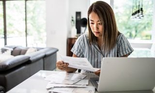 Woman paying bills at home