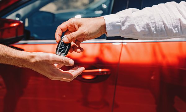 Person getting the key to their new car