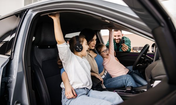 Family celebrating their new car