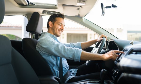 Man in car using touchscreen