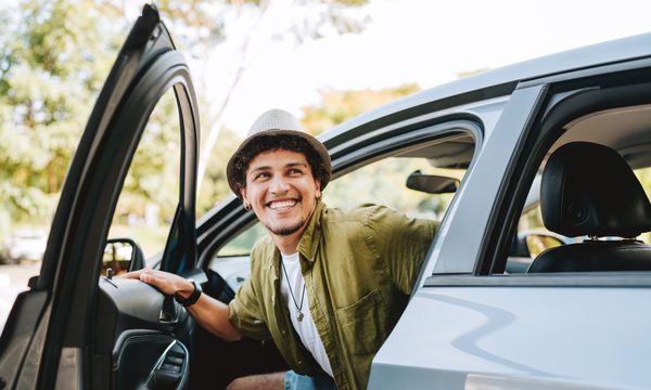 Young man getting out of car