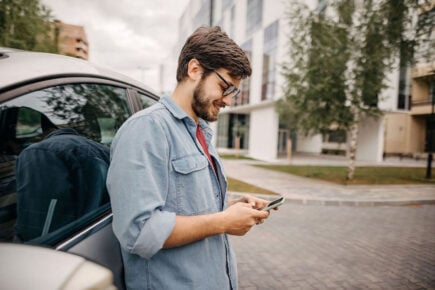 Man using phone to look for car insurance