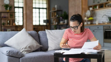 Woman in her home looking for ways to save on her mortgage