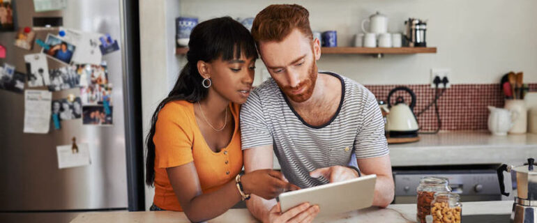 Young couple looking at interest-only mortgages on ipad