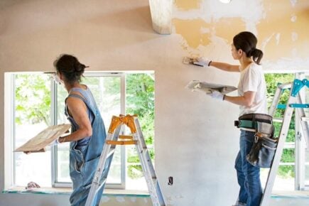 Two women making home improvements