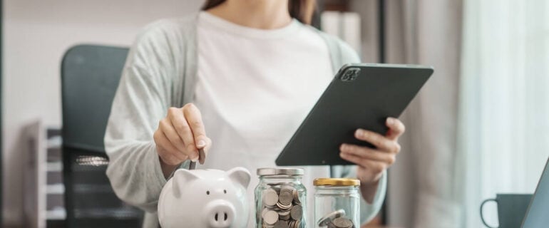 Woman using tablet to compare ISA savings accounts
