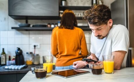 Man in his kitchen looking at rising mortgage rates